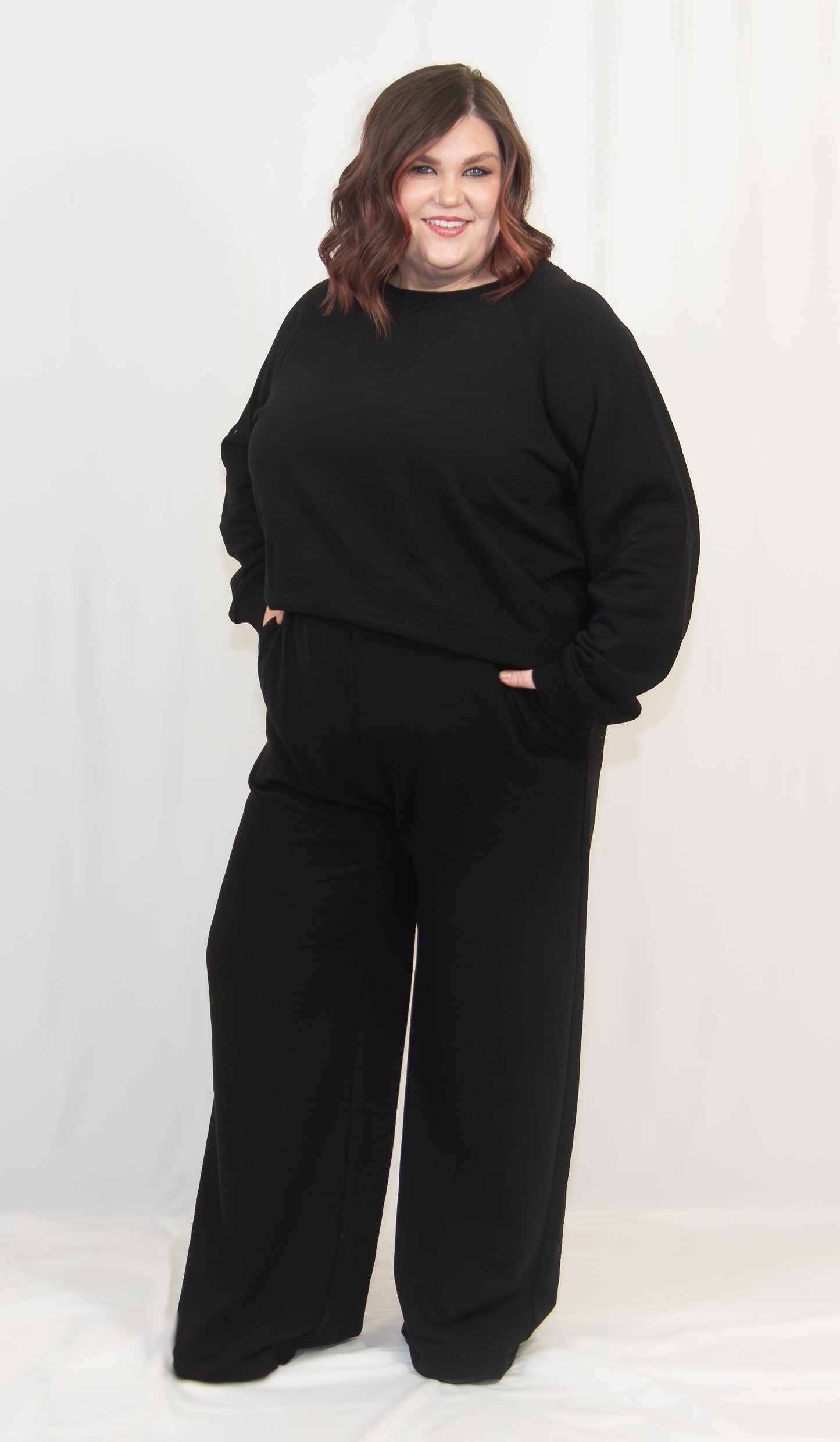 Person wearing a black outfit on a white background